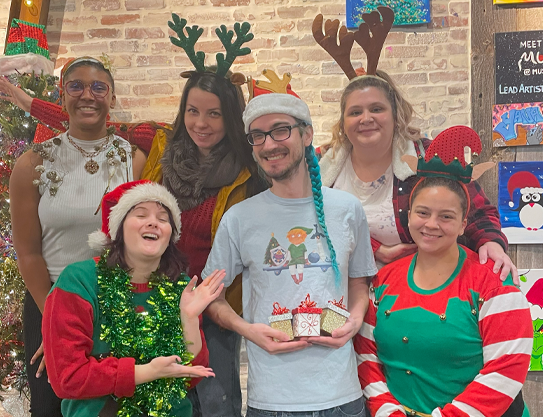 Friends in festive Christmas attire posing together