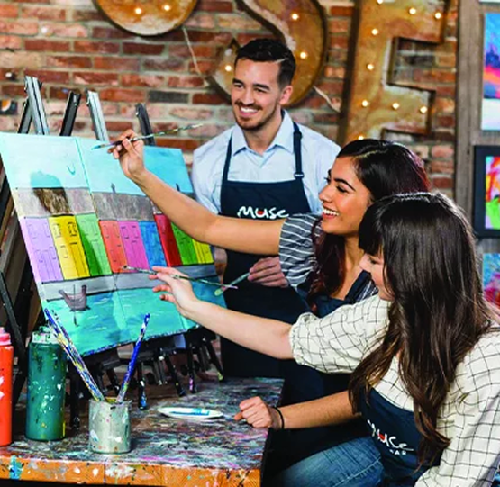 Couples painting at a studio